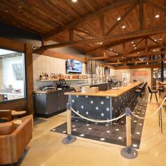 Glulam trusses are a great solution for retail projects given their capacity for customization, seen here with a dark finish that evokes traditional timber buildings.