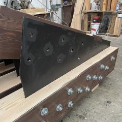 An up-close look at the internal hardware of this truss assembly, which ensures the stability of the structure without encasing the wood exterior.